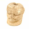 Carved head of bone, pierced through the middle for suspension. Votive offering. 