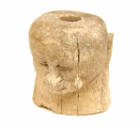 Carved head of bone, pierced through the middle for suspension. Votive offering.

