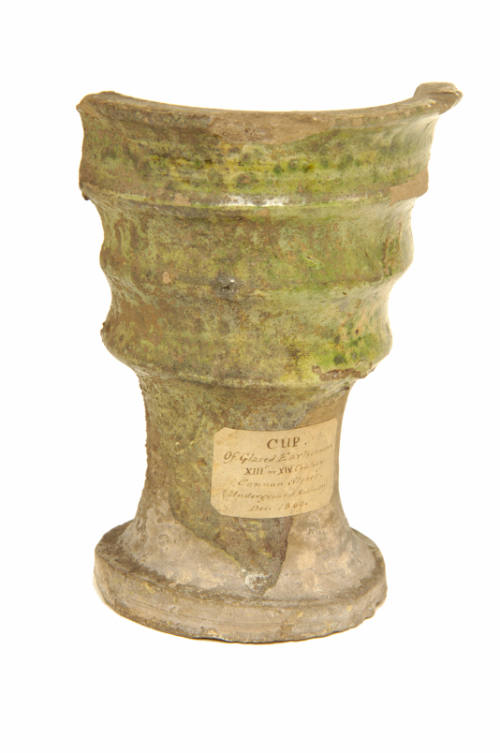 Earthenware green glazed cup . 
