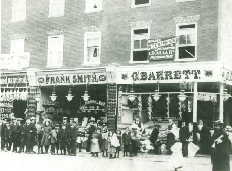 Black and white photograph of G. Barrett fishmonger and Frank Smith, greengrocer. 24 and 24a Pe…