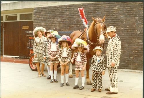 Colour photograph of the Pearly King and Queen of Peckham, the Major family, posing with their …